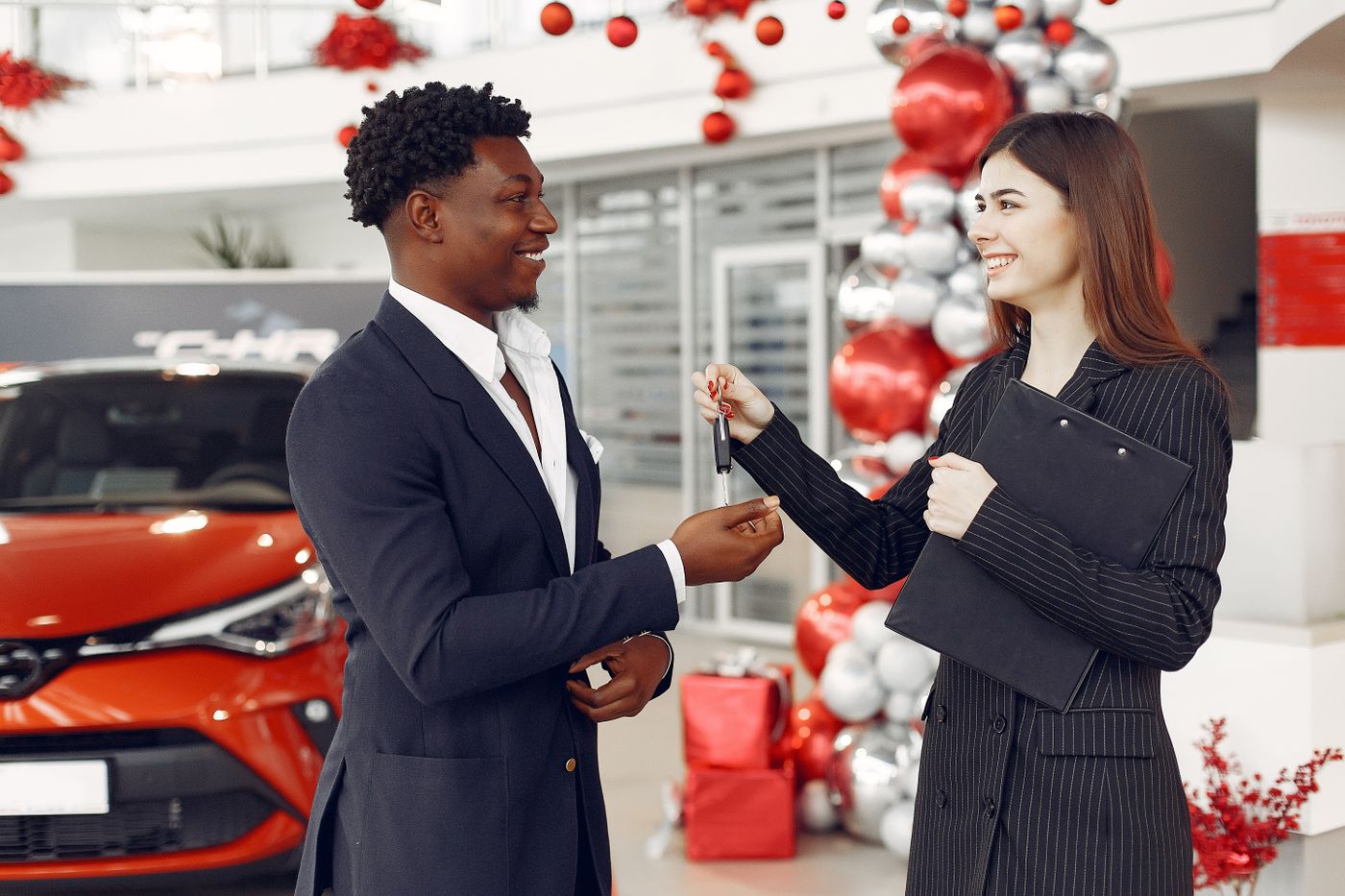 Handing over car keys to a rental customer